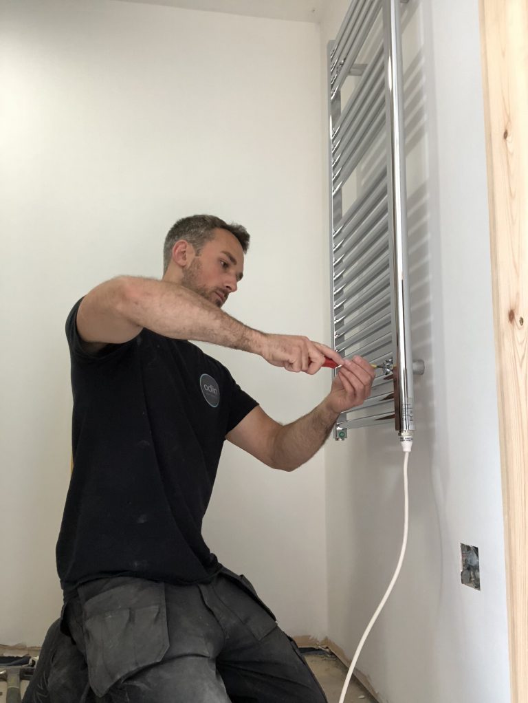 Fitting an electric towel rail in an ongoing barn conversion, in